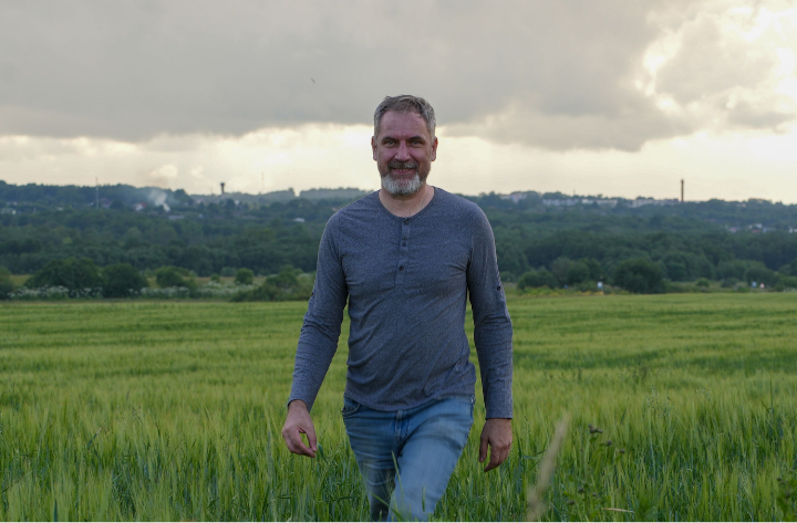 Man walking in field.