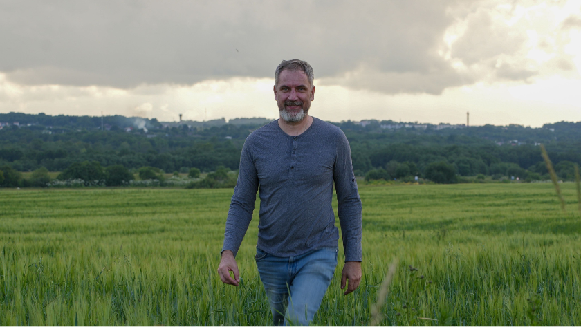 Man walking in field.